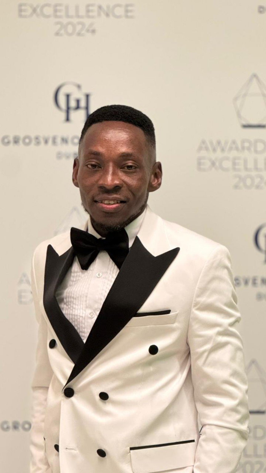 William in formal attire at an excellence awards event